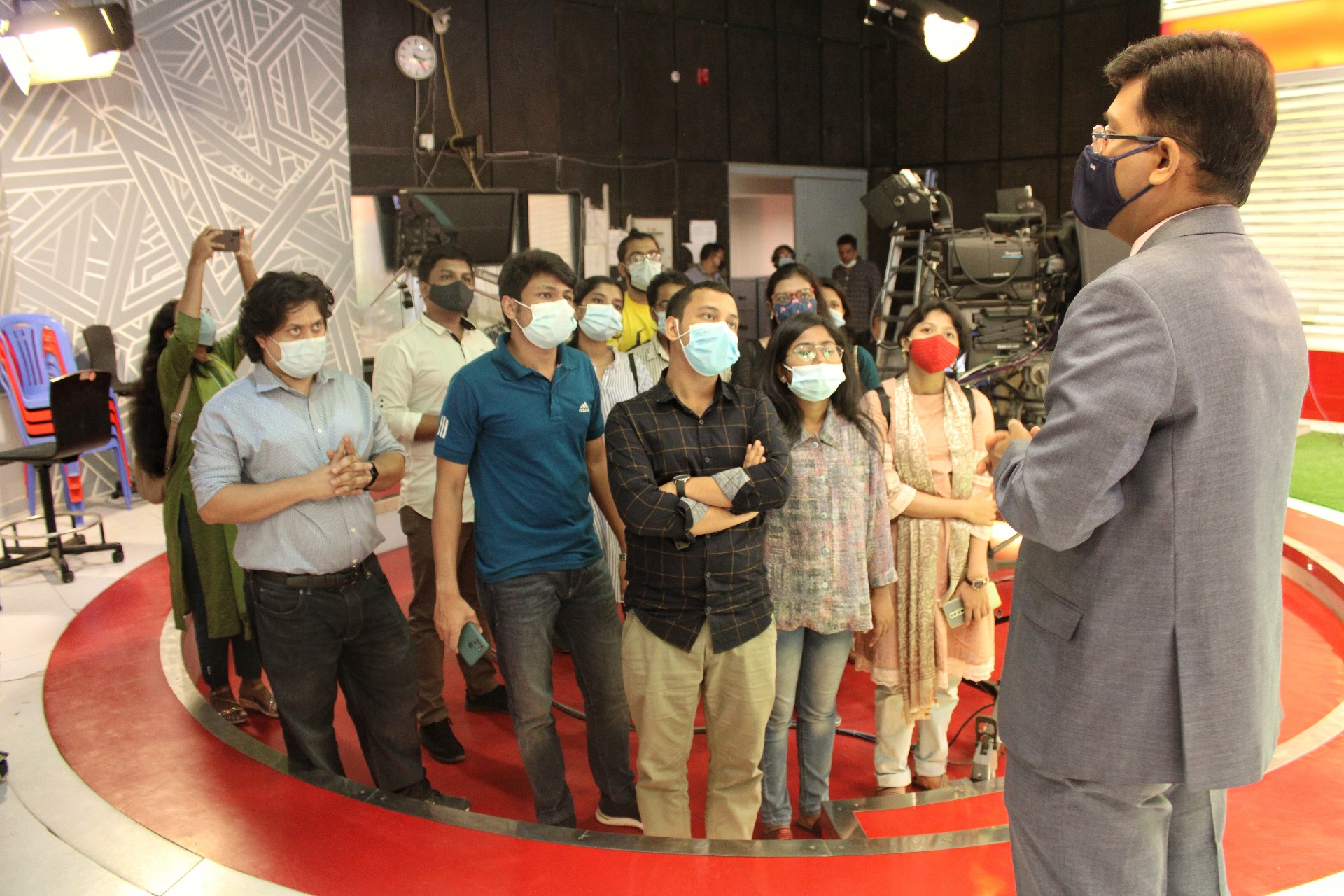 inner_1_a_news_presenter_at_channel_i_talks_to_fellows.jpeg