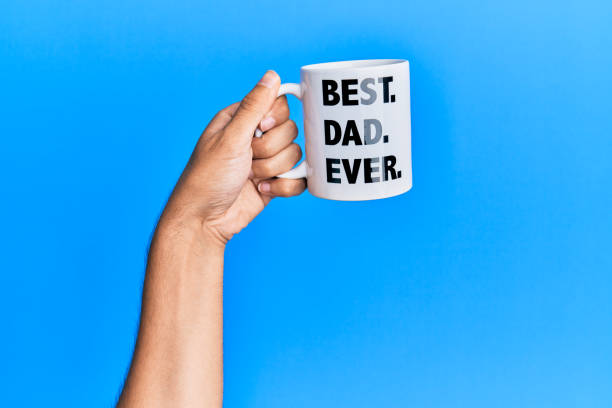 hand-of-hispanic-man-holding-best-dad-ever-coffee-cup-over-isolated-picture-id1281100613.jpg