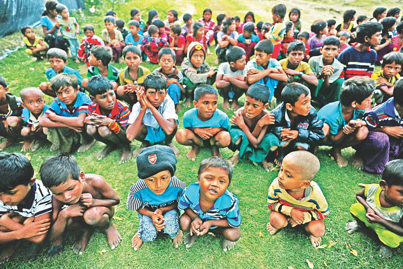 Rohingya refugee children wait to cross Bangladesh border