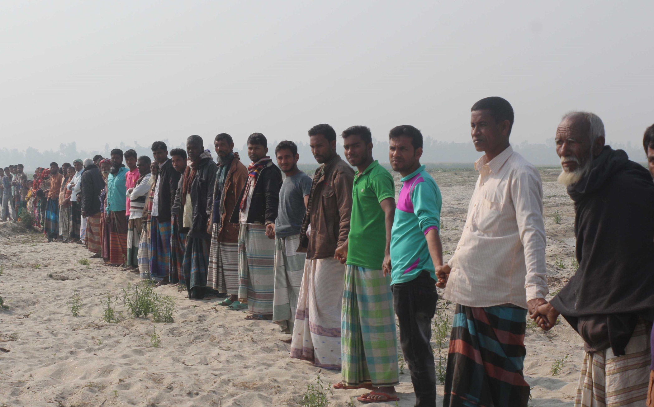 spare_dried_riverbed_human_chain.jpg