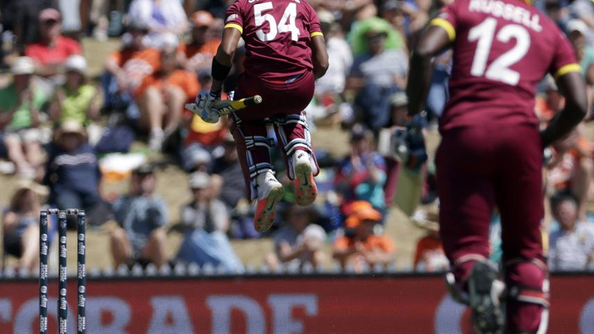 Lendl Simmons jumps after scoring 100.JPG