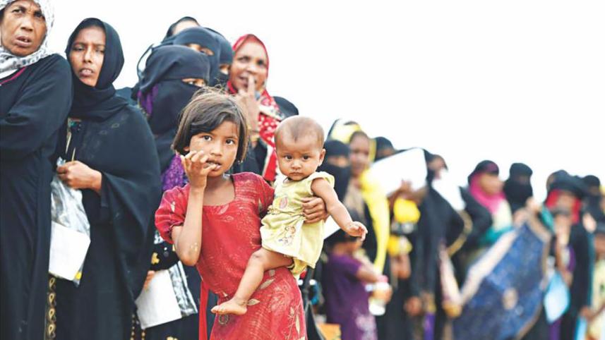 A rohingya girl holding a child 
