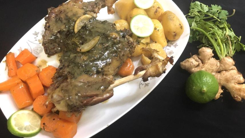 Whole mutton leg roast with baked vegetables 