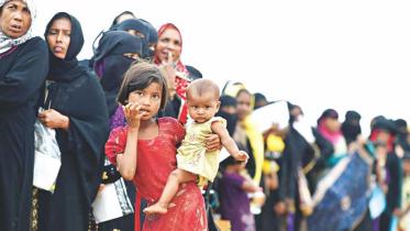 A rohingya girl holding a child 