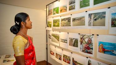 pushpa_rani_mondol_project_participant_enjoying_the_photo_exibition_which_is_telling_powerful_sociol_ecological_resilience_building_stories_of_her_community.jpg